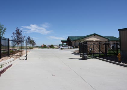 view of storage area gate with our office in background